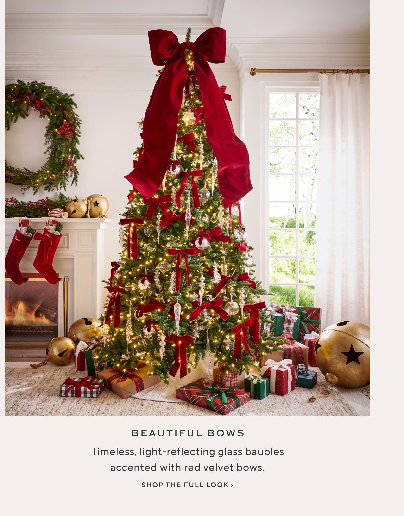 Beautiful Bows: timeless, light-reflecting glass baubles accented with red velvet bows. Shop the full look.